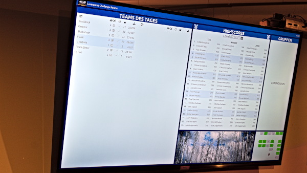 A screen displaying a scoreboard with team names and scores