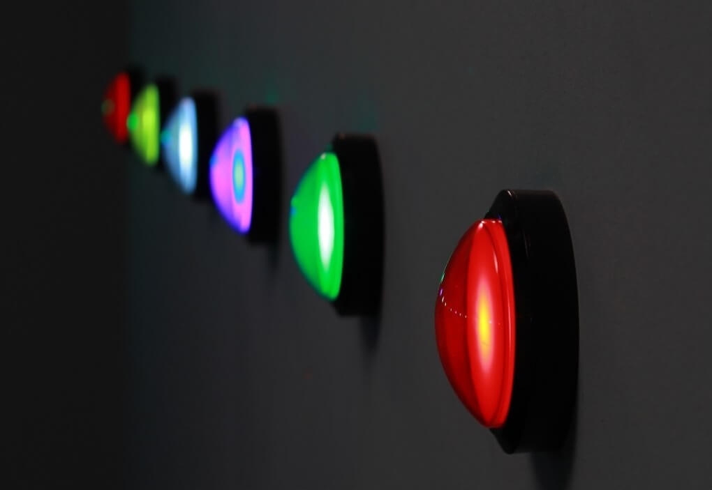 A row of large, round, brightly glowing buttons