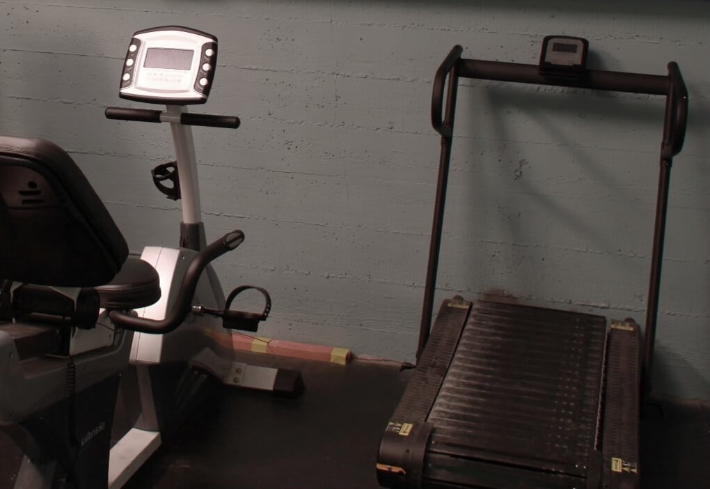 An exercise bike and a treadmill side by side