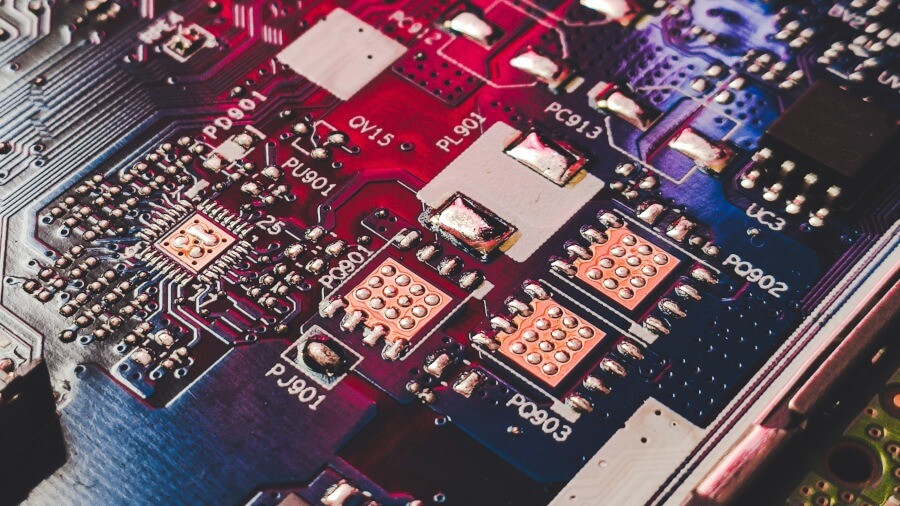 Close-up of a colourful circuit board showcasing various microchips and electronic components