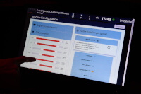 A finger touching a screen with many settings options